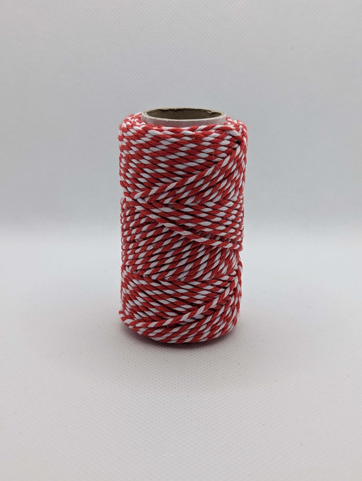 Image of a roll of 20m Bakers Twine. The colour is Red and white stripes. Great for wrapping packages and presents/ gifts.