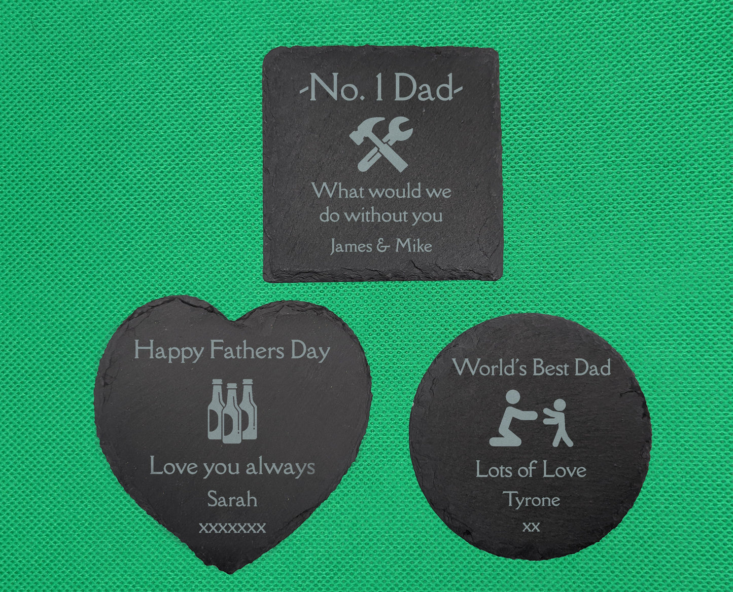 Three slate coasters. The square is engraved with No. 1 Dad What would we do without you with an image of a Wrench and hammer.. The Heart says Happy Fathers Day Love you always with beer bottles image and the circle has Worlds best dad Lots of love