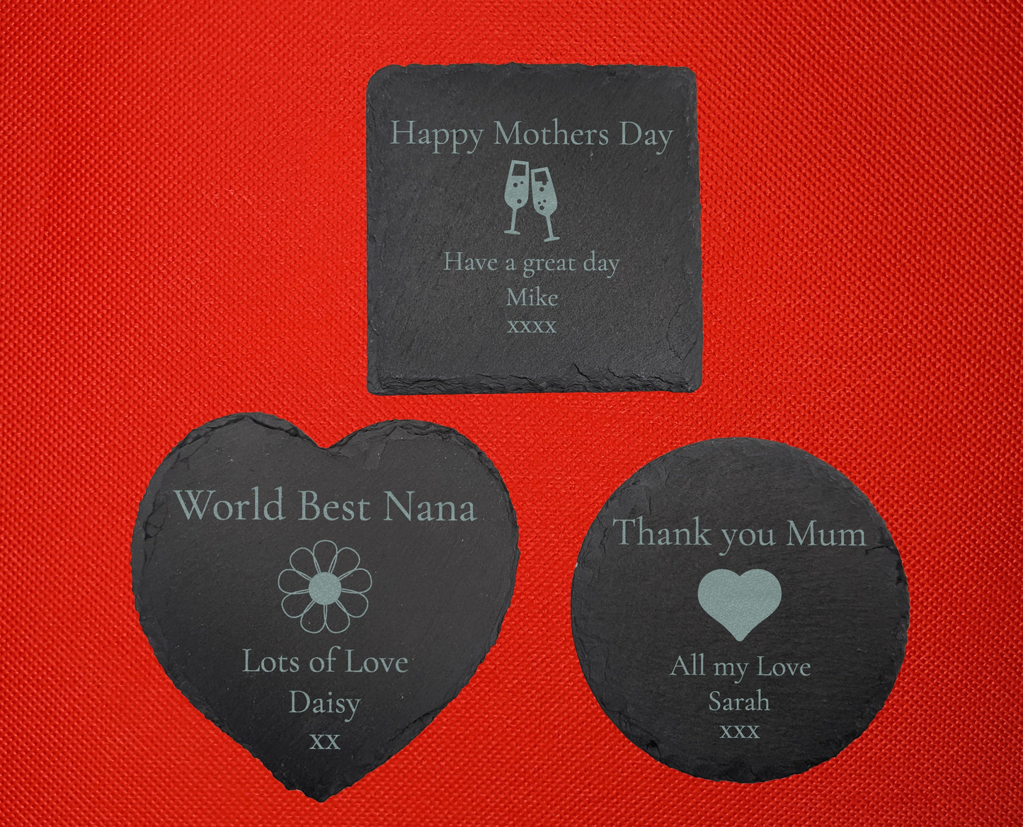 3 slate coasters engraved with mum themes. Square has Happy Mothers day Have a great day with image of Champaign glasses. Heart has Worlds best Nana Lots of Love with a daisy flower image. Circle has Thank you mum All my love with a heart image.