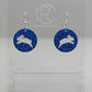 A pair of acrylic earrings that have Silver ear wire hook fixings. They are Circles with an Easter bunny / rabbit hopping up cut out each one. It is Royal Blue Glitter colour. They are against a white background on see through stands.