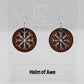 A pair of circle earrings with silver ear wire hook fixings. Cut out of the centre is the Helm of Awe Nordic charm. They are made from walnut wood. They are against a white background on a clear stand with the Ravenstor Creative logo on it.