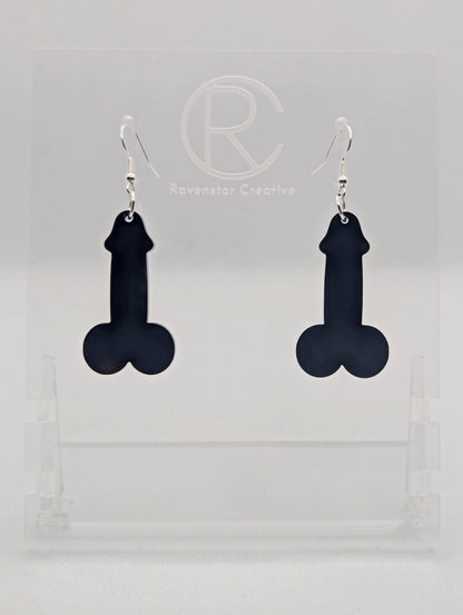 Image of a pair of earrings shaped like a Penis and Balls with Silver ear wire hook fixings. These are ideal for funny Hen Dos or Bachelorette parties. The colour is Black and they are on clear stands against a white background.