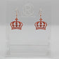 Shows a pair of acrylic earrings with Rose Gold ear wire hook fixings. They are Royal Crown shapes. The colour is Copper Glitter. They are against a white background on clear stands with the Ravenstor Creative logo.