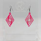 These are acrylic diamond shape earrings with twisted Geometric patterns cut into the middle. They have black ear wire hook fixings and they are hot pink in colour. They are on a clear stand against a white background.