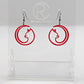 Shows a pair of acrylic earrings that have black ear wire hook fixings. They are Full Moon inspired Cat shapes. They are in translucent red and are against a white background on see through stand with the Ravenstor Creative logo on it.