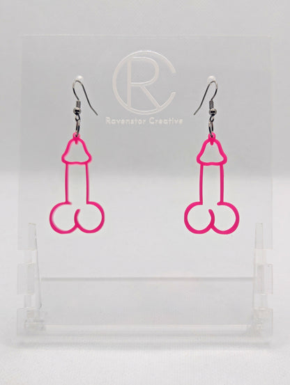 Image of a pair of earrings shaped like a Penis and Balls with Black wire hook fixings. These are ideal for funny Hen Dos or Bachelorette parties. The colour is Hot Pink and they are on clear stands against a white background.