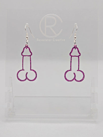 Image of a pair of earrings shaped like a Penis and Balls with Silver ear wire hook fixings. These are ideal for funny Hen Dos or Bachelorette parties. The colour is Pink Glitter and they are on clear stands against a white background.